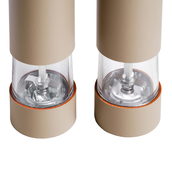 Two beige salt and pepper shakers on a white background
