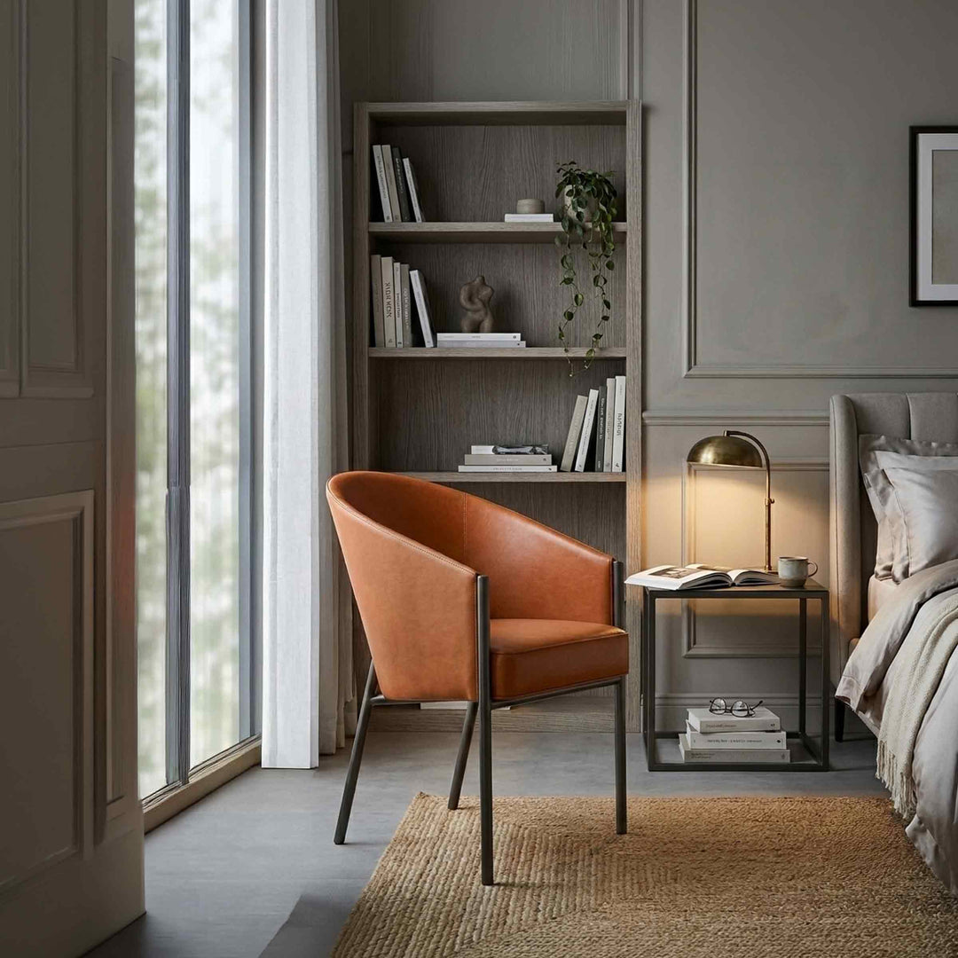 Leather Chair COSTES by Philippe Starck for Driade in a reading corner of a bedroom