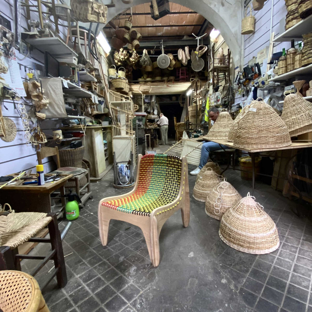 Spider chair by Jules Regis, oak wood structure with braided multicolor boat rope seating, contemporary designer chair in a shop
