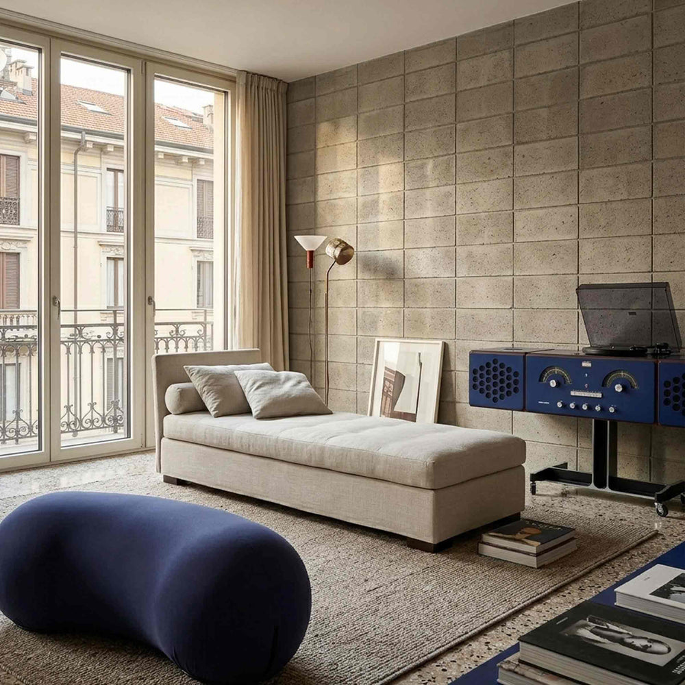 white Sofa Bed isolino by Orizzonti Design Center for Horm, with the blue Bluetooth Radioradiografo by Brionvega and blue Footrest tato bean by Denis Santachiara & Enrico Baleri for Baleri Italia