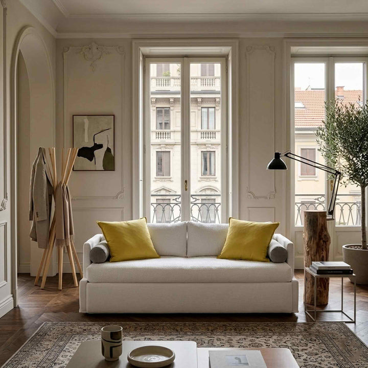 white Sofa Bed ISOLOTTO by Orizzonti Design Center for Horm, with Floor Lamp piantama by Mogg and the Wood Clothes Hanger sciangai by Zanotta